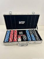 Open poker set showing chips, dice and case interior