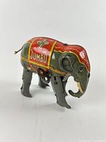 Left side view of tin litho wind-up elephant showing Jumbo blanket graphics and leg detail