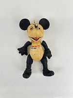 Front view of Mickey Mouse plastic figure showing overall design, colour scheme, loop hanger and wear