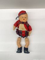 Full view of doll with detached legs and Scottish attire