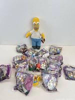 Group shot showing Homer plush and sealed Burger King Spooky Light-Up toys