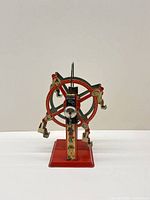Full view front of tin Ferris wheel on base