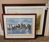 Front view of both framed prints leaning against wall