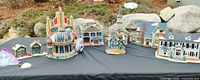 All nine Lemax village buildings displayed on table