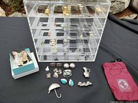 Overall view of jewelry pieces, acrylic organizer, boxes and pouch