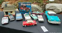 Front view of all cars, book, cottage, birdhouse and airplane