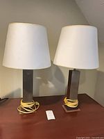 Both lamps unplugged with shades on tabletop