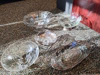 Five etched glass pieces arranged on carpet