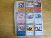 Front view of nine Japanese Pokémon cards in binder page
