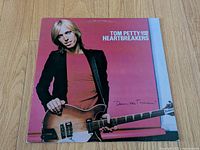 Front album cover featuring Tom Petty with guitar