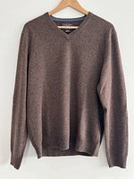 Front view of brown V-neck sweater on hanger