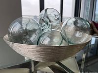overview of silver-tone bowl holding clear glass spheres