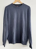 Front view of blue cashmere sweater on hanger