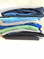 Stack of folded T-shirts showing variety of colors