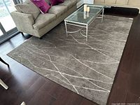 Full view of carpet in living room setting showing grey color and cream pattern