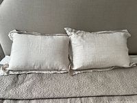 Pair of linen pillowcases on bed