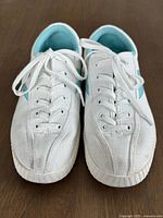 Top view of both sneakers showing laces, canvas uppers, and toe caps