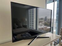 Front angled view of Samsung 49-inch TV on stand