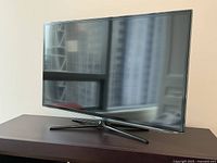 Front view of Samsung flat screen TV on stand