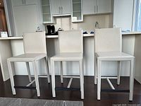 Front view of all three cream bar chairs