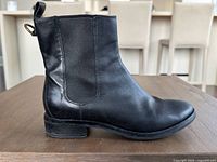 Left side profile of right boot showing leather condition, heel, sole edge