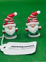 Front view of two Department 56 Candy Cane gnome figurines