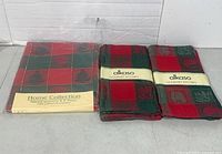 Packaged Home Collection tablecloth and two stacks of Alkaso tea towels