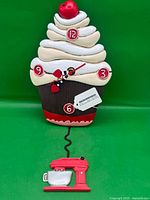 Full view of cupcake wall clock with mixer pendulum