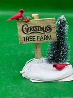 Front view of Department 56 Christmas Tree Farm sign with cardinals and tree