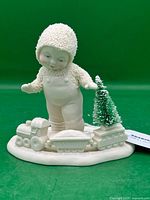 Front view showing Snowbaby, train, tree