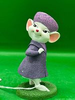 Front left view of Miss Bianca figurine on base