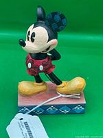 Front view of Mickey Mouse figurine on patterned base