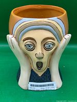 Front view of Scream planter showing face design and open top