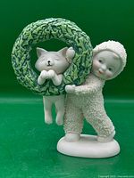 Front view showing Snowbabies child, wreath, and cat