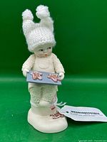 Full view of Snowbabies figurine with tag attached