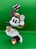 Front view of Minnie Mouse figurine showing pop-art colours and gold accents