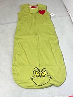 Full view of green wearable blanket with Grinch face and zipper