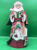 Front view of full Santa figurine showing title panel and scene