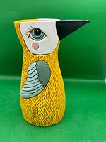 Front view of ceramic mustard bird watering can/vase