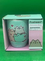 Front view of boxed mug showing pastel Pusheen design and product labeling