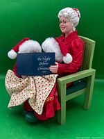 Front view of Mrs. Claus figurine reading to children