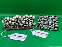 Both skull walls front view on green backdrop with tags