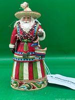 Front view of Mexican Santa figurine showing full outfit and piñata