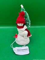 Front view of Snowbabies figurine with tree and cardinal
