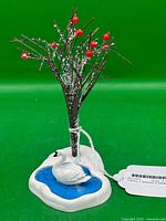 Full view of figurine showing tree, berries, pond, and swan