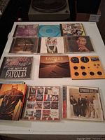 Top view of eleven CD jewel cases showing front artwork for identification