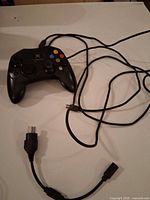 Controller front showing buttons, analog sticks, wire