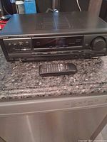 Front view of Technics EX310 receiver with remote placed in front
