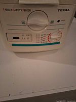 Front view showing brand, model name, control panel, staining