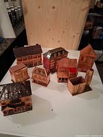 Group shot of all eight vintage cardboard HO scale buildings on tabletop